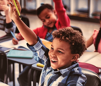 School child with hand raised